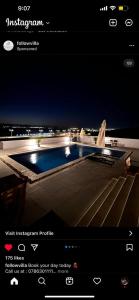 a picture of a swimming pool at night at Follow Sea Villa in Sowayma
