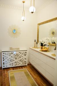 a bathroom with a dresser and a mirror at Luxury Apartment Karic FREE parking in Tuzla