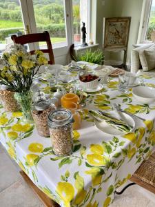 a table with a table cloth with lemons on it at The Garden Room at Sleepy Hollow in Louisburgh