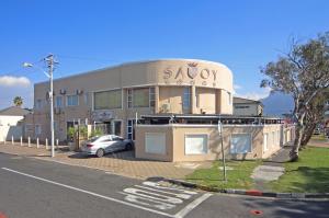 a building with a car parked in front of it at Savoy Lodge in Cape Town