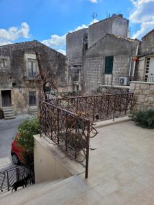 an old building with a staircase in a courtyard at Casa Alecci 1820 in Modica