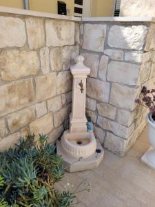 a stone toilet sitting next to a stone wall at Casa Alecci 1820 in Modica +48 photos