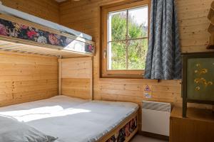 1 dormitorio con 2 literas y ventana en Am Bühl EG, en Bettmeralp
