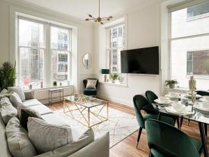 a living room with a couch and a table at Large Blythswood Residence in Glasgow