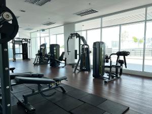 a gym with treadmills and machines in a building at Kuching Tabuan Tranquility Apartment TT3 Soho C11 in Kuching