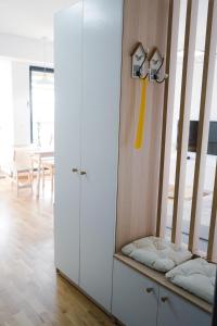 a room with a white cabinet with pillows on it at Sunlight Apartment in Skopje