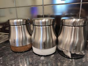 three silver coffee grinders sitting on top of a counter at City Centre 2 bedrooms 2 Ensuite Flat free parking in Nottingham