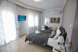 una camera con due letti e una grande finestra di C.L.A. 2 City Lux Apartment Alaxandroupoli a Alexandroupoli
