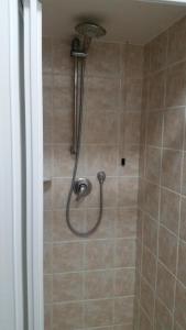 a shower with a shower head in a bathroom at Affittacamere Il Giramondo in Foligno +51 photos