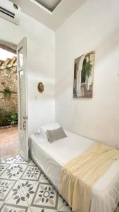 a white bedroom with a bed in a room at Casa Ego in Cartagena de Indias