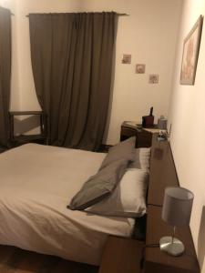 a bedroom with a bed and a desk and a window at La Tenuta di Leo in San Giovanni in Persiceto