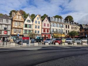 a city street with cars parked in front of buildings at House of secrets in Morlaix