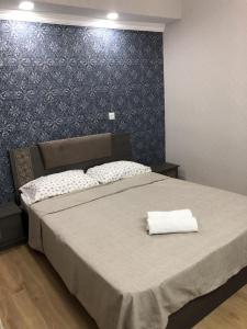 a bedroom with a bed with a white towel on it at Valera Homestay in Tbilisi City