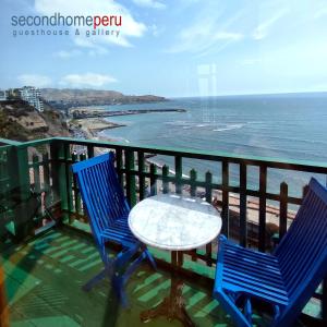 a table and chairs on a balcony overlooking the ocean at Second Home Peru in Lima