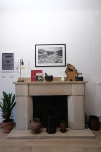 un salon avec une cheminée avec un tableau au-dessus dans l'établissement Vico Antico, à San Martino dʼAgri