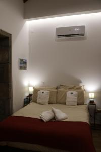 a bedroom with a large bed with white pillows at Casa da Boa Vista in Algarvia