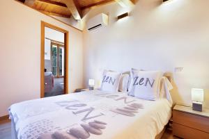 a bedroom with a white bed with the word help written on it at Tower House with emotional shower in Ancaiano