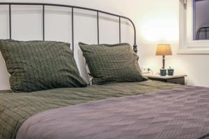 a bed with two pillows on top of it at wellness chalet met jacuzzi, sauna, omheinde tuin, in Sint Annaland +40 photos