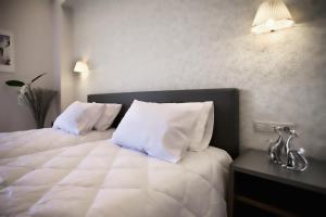 Postel nebo postele na pokoji v ubytování Astron Hotel