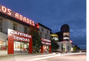 a building with red signs on the front of it at Hotel Abades Loja in Loja +16 photos