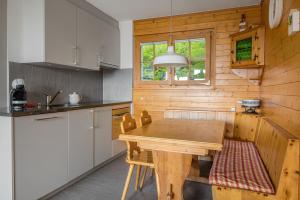 a wooden kitchen with a wooden table in a room at Tschiffra EG in Bettmeralp