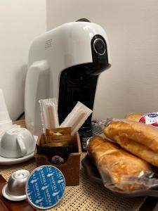 a coffee maker and some bread on a table at Beb dell arechi in Salerno