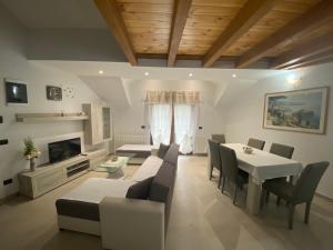 a living room with a table and chairs and a fireplace at APARTMAN GALERIJA in Ogulin