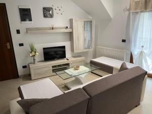 a living room with a couch and a tv at APARTMAN GALERIJA in Ogulin +56 photos