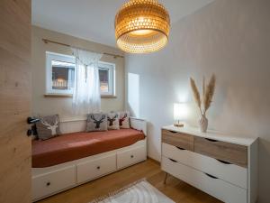 a bedroom with a bed and a chandelier at Ferienwohnung "Tiroler Alpenzauber" in Sankt Johann in Tirol