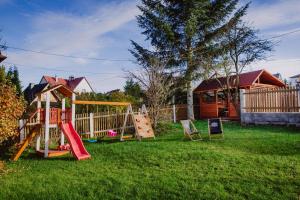 a yard with a playground with a slide at Willa Dalia in Rabka