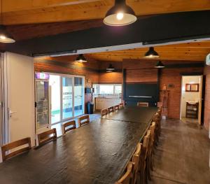 a large long table in a room with chairs at Apart Hotel Naga Huel in Sierra de la Ventana +59 photos