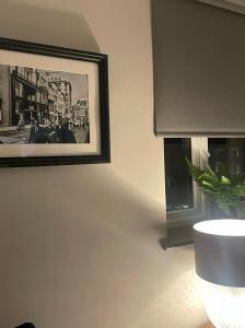 a picture hanging on a wall next to a window at Phoenix Pods in Liverpool