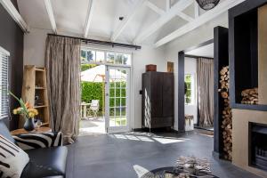 a living room with a fireplace and a glass door at 14 on Klein Constantia in Cape Town