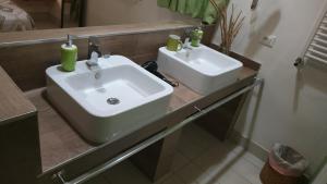 a bathroom with a white sink and a mirror at casammare in Paola