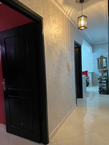 a black door in a room with a hallway at Appartement Tanger in Tangier