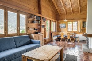 a living room with a couch and a table at Trimka in Fiesch
