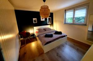 a bedroom with a bed and a window at Ferienwohnung Am Musbach in Badenweiler-Sehringen in Badenweiler