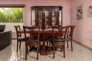 a dining room with a wooden table and chairs at Villa Salinas - Relax in the paradise surronded by nature and heated swimpool in Paul do Mar