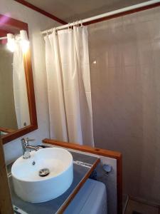 a bathroom with a white sink and a mirror at Studio "Le Panpounet" in Les Contamines-Montjoie