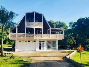 a large house with a balcony on top of it at Casa Grande Vacation Home and Events Venue in Rio Grande