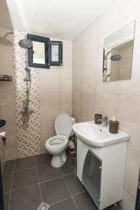 a bathroom with a toilet and a sink at ECO Hоuses - Camping Gradina in Chernomorets