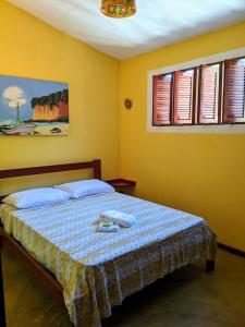 Ένα ή περισσότερα κρεβάτια σε δωμάτιο στο Casinha Amarela