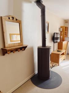 a black stove in a room with a mirror at Appartement La Tania in Courchevel