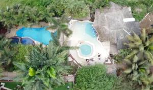 an aerial view of a resort with two swimming pools at ME Hotel & Villas - Montañita Estates in Montañita