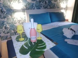 a bedroom with a bed with a bottle and two glasses at Bnb Simy2 in Naples