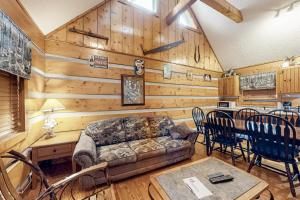 a living room with a couch and a table at Dances with Wolves in Pigeon Forge