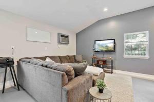 a living room with a couch and a table at Fox Cottage in Catonsville