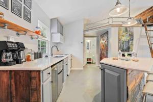 a kitchen with white counter tops and wooden cabinets at Fox Cottage in Catonsville