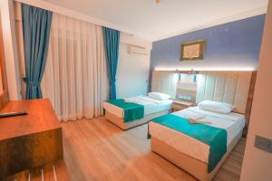 Postel nebo postele na pokoji v ubytování Hotel Amore