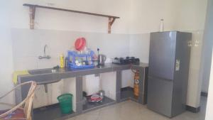 a kitchen with a counter and a refrigerator at Marashi Villa in Nungwi